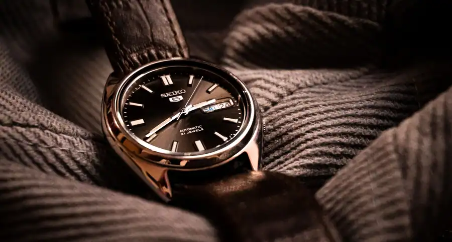 Close-up of a Seiko wristwatch on a textured fabric. Perfect for timepiece enthusiasts.